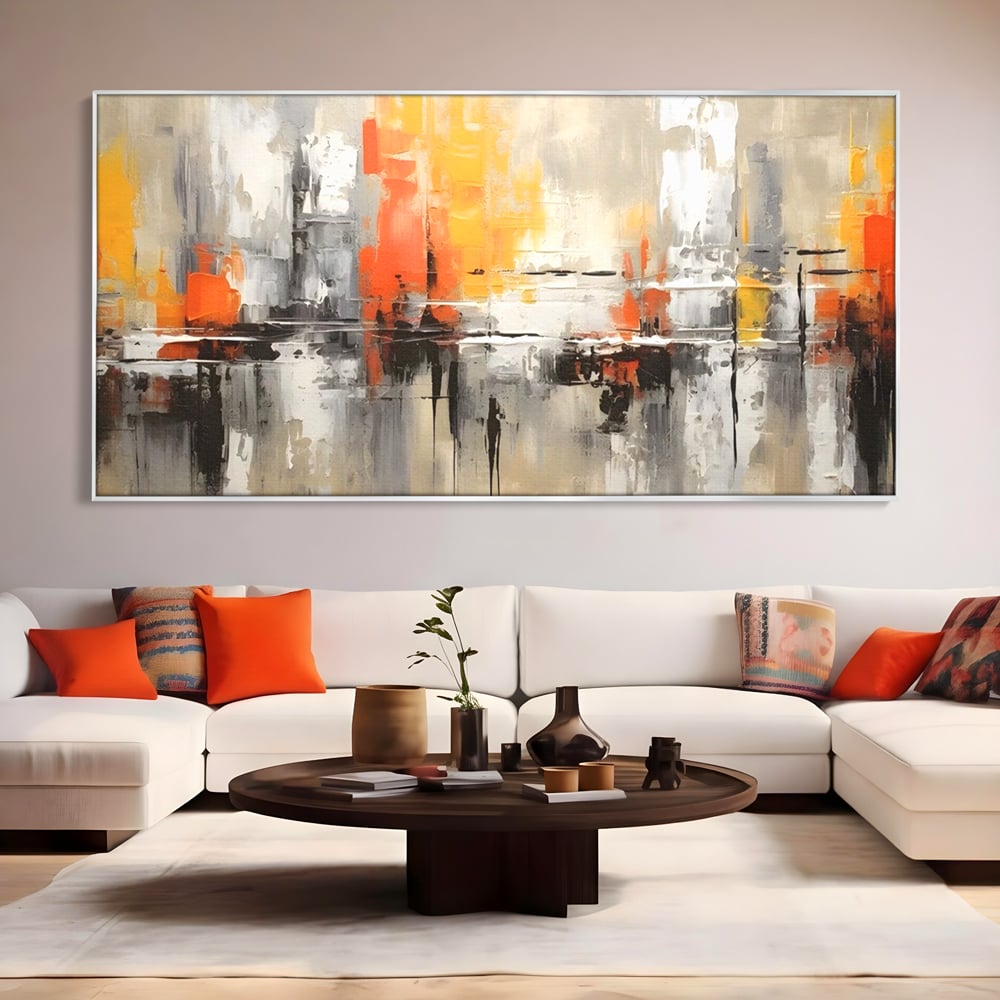 Tablou canvas cu pictura abstracta cu turnuri portocalii, in rama de aluminiu argintiu, pe perete intr-un living